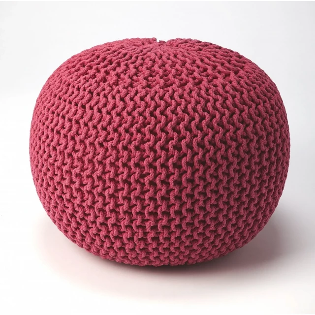 alt=Pink round pouf ottoman with patterned design