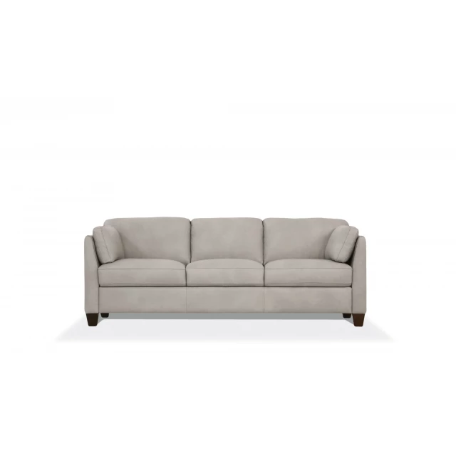 dusty white leather black sofa with pillows in a comfortable outdoor setting