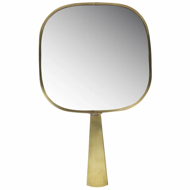 Gold Greek key hand mirror displayed with yellow furniture and drinkware in an online shop