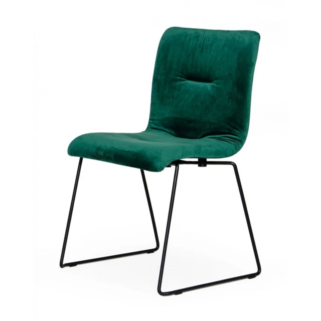 Emerald green velvet dining chairs with comfortable armrests and wood accents