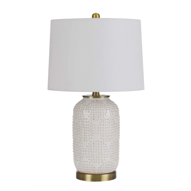 metal table lamp with white drum shade on table