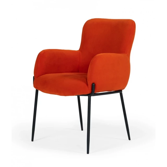 Orange velvet dining chair with armrests and wooden flooring