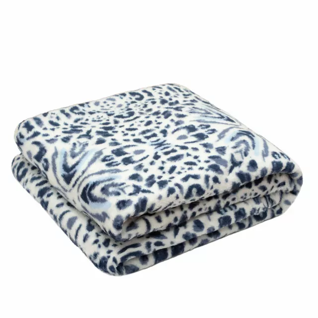 Blue reversible velvet sherpa throw blanket on outdoor furniture
