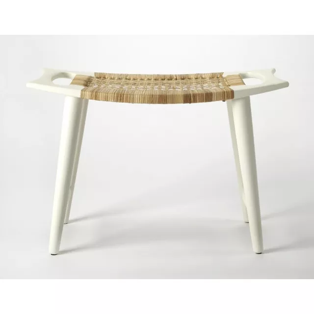 White ottoman furniture piece in a natural wood setting