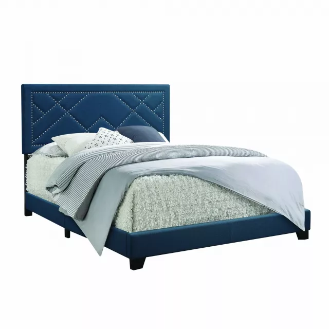 Standard bed with upholstered nailhead trim headboard in elegant bedroom setting