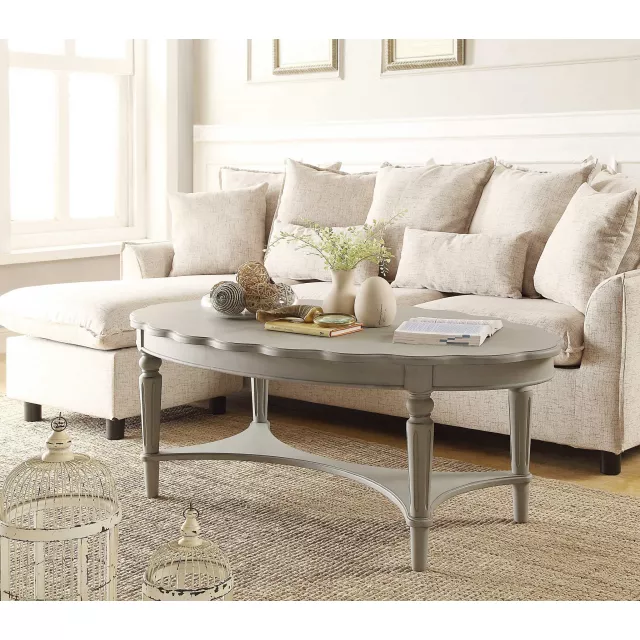 Antique white coffee table in a well-designed interior with couch and window
