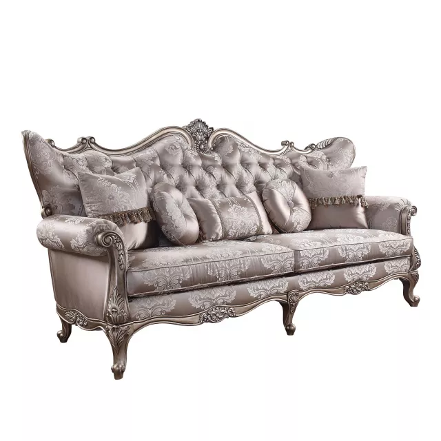 Silk champagne sofa with five toss pillows and comfortable armrests in a studio setting