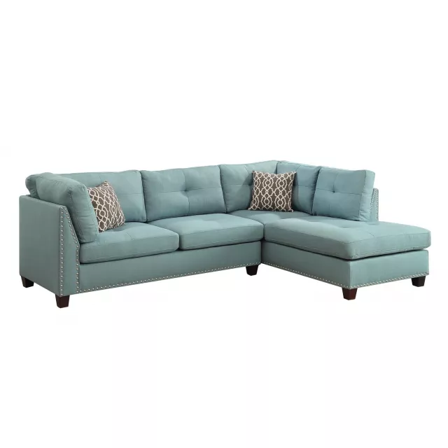 Blue linen L-shaped sofa chaise with studio couch design in an interior setting