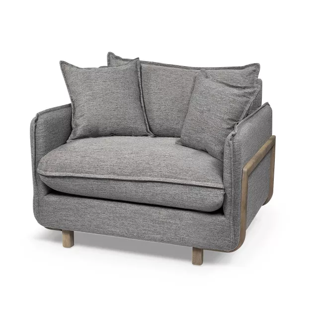 Gray linen arm chair with pillow on a studio couch setup in a comfortable furniture arrangement