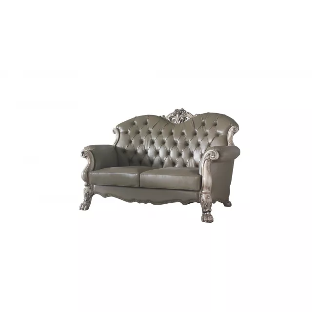 Bone faux leather loveseat with toss pillows and wooden armrests