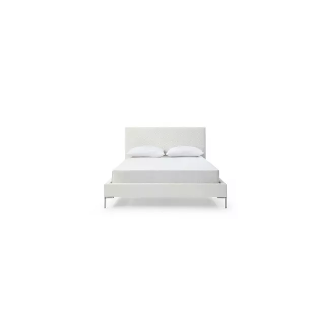 Full white upholstered faux leather bed in a modern bedroom setting