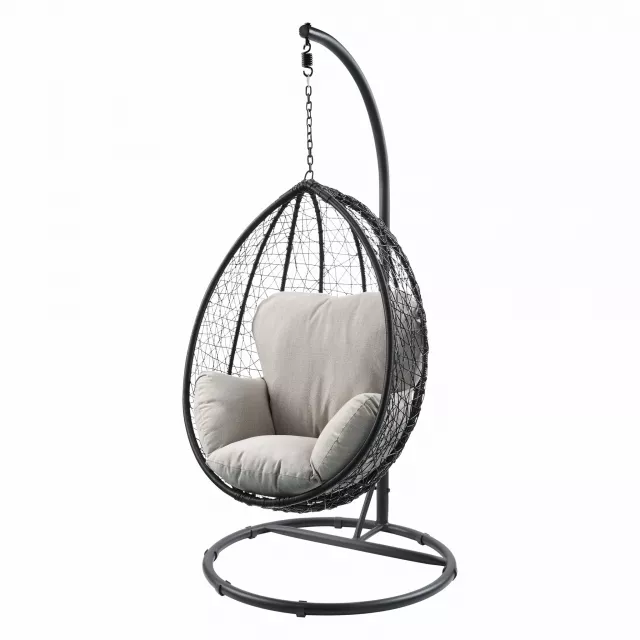 Black metal swing chair with beige cushion for outdoor patio