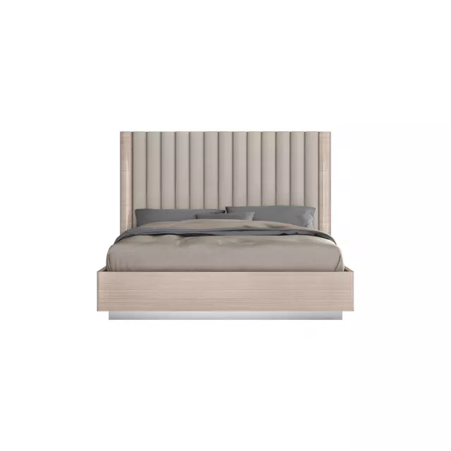 Beige upholstered channeled headboard bed frame in a bedroom setting
