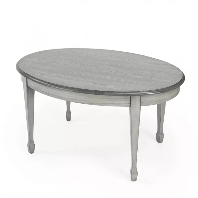 Gray oval distressed coffee table with wood stain finish in outdoor setting