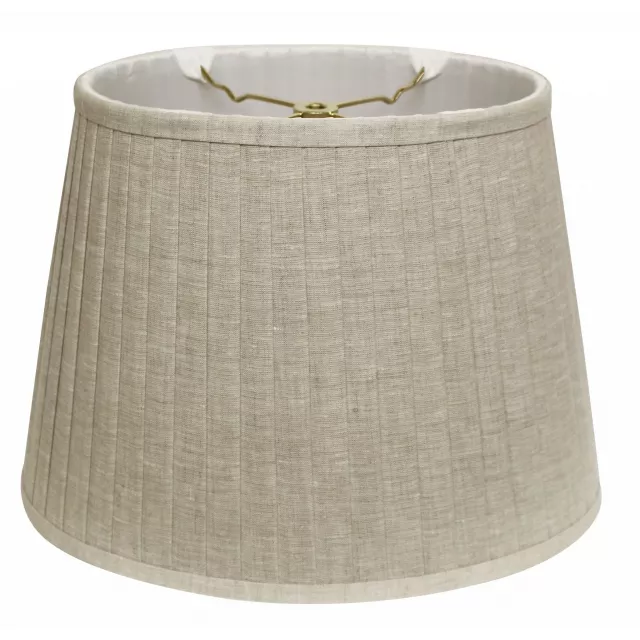 Cream slanted oval paperback linen lampshade on wooden surface