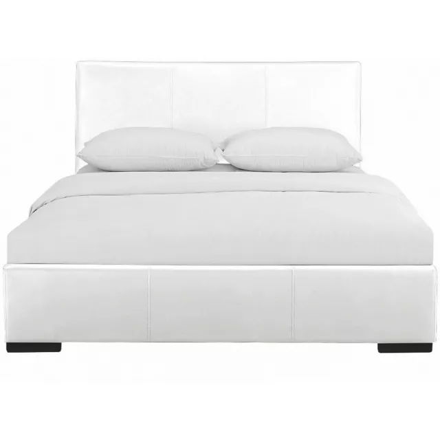 White upholstered queen platform bed in a modern bedroom setting
