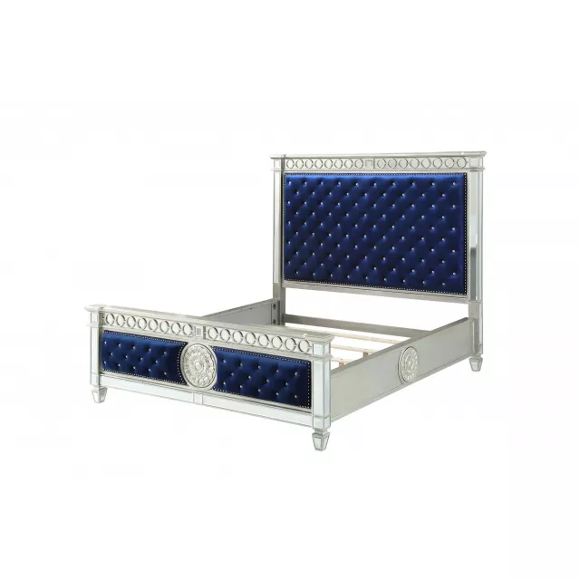 Blue upholstered velvet bed with nailhead trim