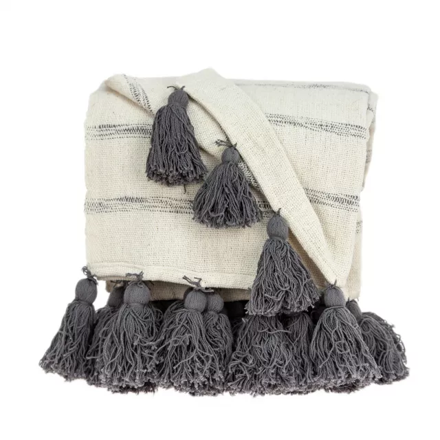 White woven cotton solid reversable throw displayed as outerwear with woolen beige bag and linens