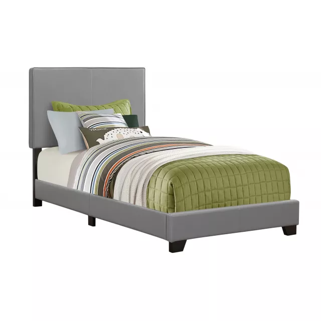 Twin gray upholstered faux leather bed in a modern bedroom setting