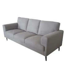 light gray linen fabric sofa with pillows in a comfortable studio setting