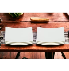 Bone china service for six with bread and butter plates on hardwood table