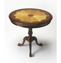 Brown round coffee table with wood and metal elements near a window