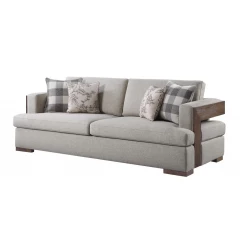 Linen brown sofa with four toss pillows in a beige studio couch setup