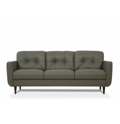Green leather black sofa with wood accents and comfortable studio couch design in furniture showroom