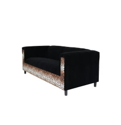 Black velvet sofa with hardwood and metal details in an outdoor setting