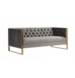 Grey gold tufted velvet Chesterfield sofa with hardwood armrests in a comfortable studio couch design