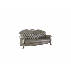 Leather white sofa with five toss pillows and comfortable armrests in a modern furniture setting