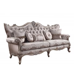 Silk champagne sofa with five toss pillows and comfortable armrests in a studio setting