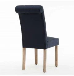 Tufted linen fabric modern dining chair with wood legs and rectangular table in background
