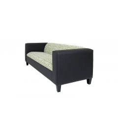 White faux leather sofa with black geometric patterns and wooden armrests
