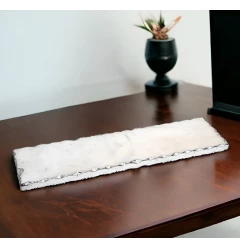 white rectangular marble vanity tray on wooden table with houseplant in background