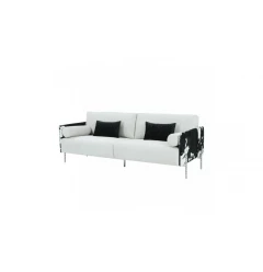 White faux cowhide silver sofa with comfortable pillows and armrests in a studio setting