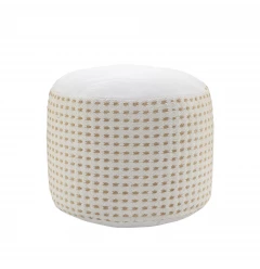 White jute round geometric pouf ottoman in a cozy interior setting