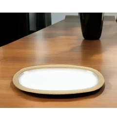 gold oval glass handmade tray on wooden table with dishware and serveware