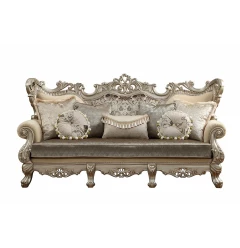 Champagne colored sofa with upholstery wood leg trim and pillows on beige rectangle outdoor furniture