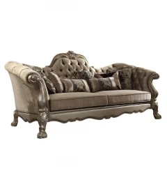 Velvet gold studio couch with seven toss pillows and hardwood details