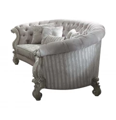 White upholstery poly resin sofa with pillows and wicker armrests for outdoor comfort