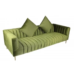 Green velvet sofa with gold toss pillows and comfortable armrests