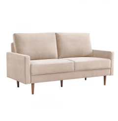 Beige velvet dark brown sofa with comfortable cushions and wooden accents in a studio setting