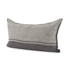 Dark gray lumbar throw pillow cover on couch with wood accents and fashion accessory elements
