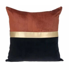 Gold black tufted velvet square pillow with patterned throw pillow on wood linen background