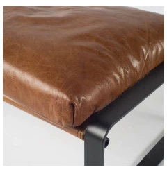 Brown faux leather ottoman in rectangle shape with natural and composite materials for comfort and style
