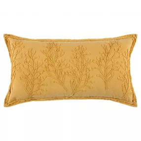 Yellow botanical pattern embroidered lumbar pillow on a couch with gold and wood accents