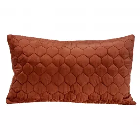 Tufted velvet quilted lumbar throw pillow on brown couch with wood accents