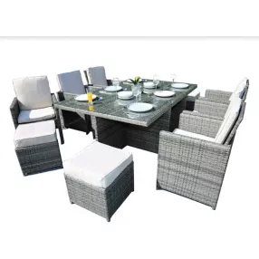 Gray outdoor dining cushions on a rectangle table with matching chairs