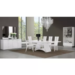 Seven white dining chairs set with rectangle wood table and plant decor